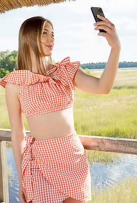 Karianne Bending Over The Railing With A Smile